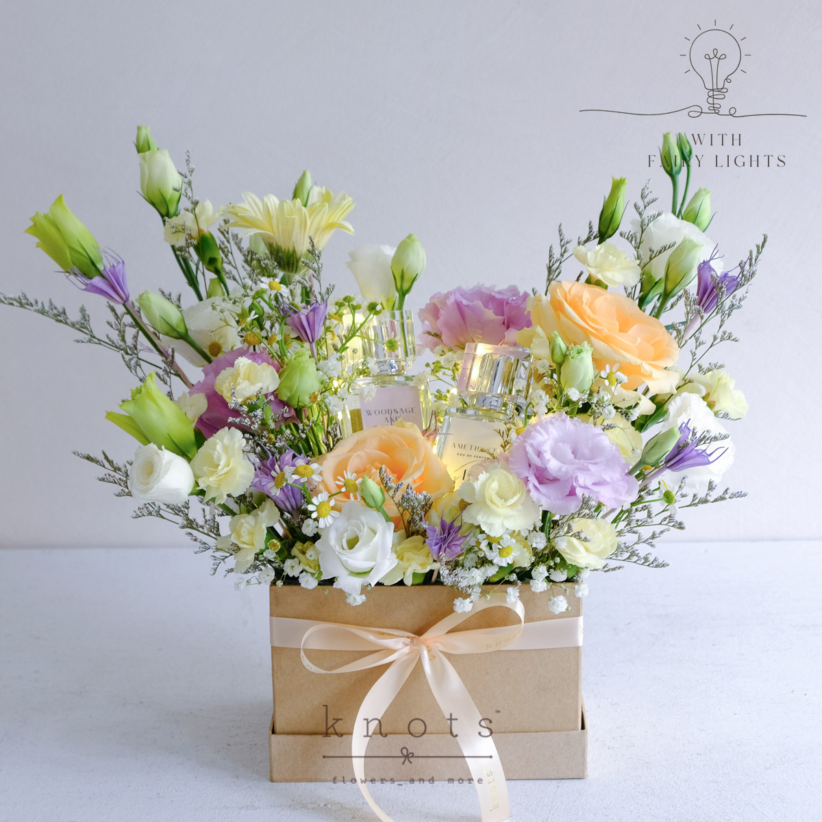 Scented Paradise (Peach Roses Arrangement with Fairy Lights and Perfumes)
