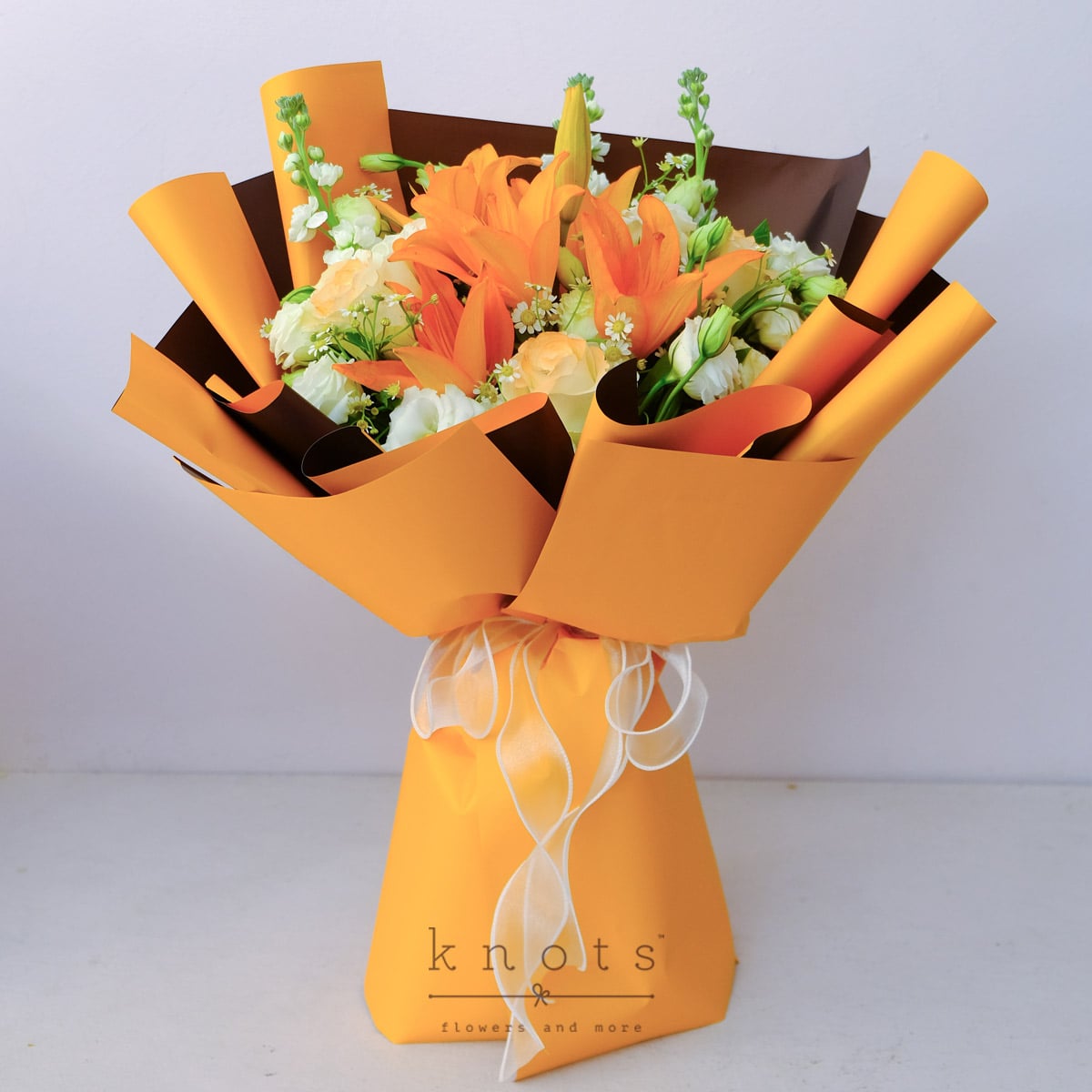 Santara (Orange Lily and Peach-Sprayed White Rose Bouquet)