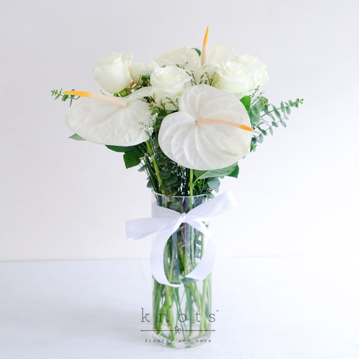 Comforting Farewells (White Roses & Anthuriums Arrangement)